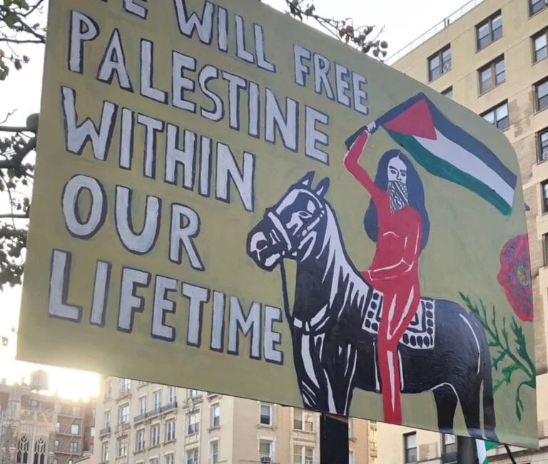 Activist protest banner supporting Palestinian independence and resistance.