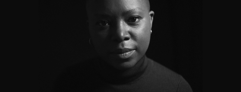 A powerful black-and-white portrait of a confident woman.