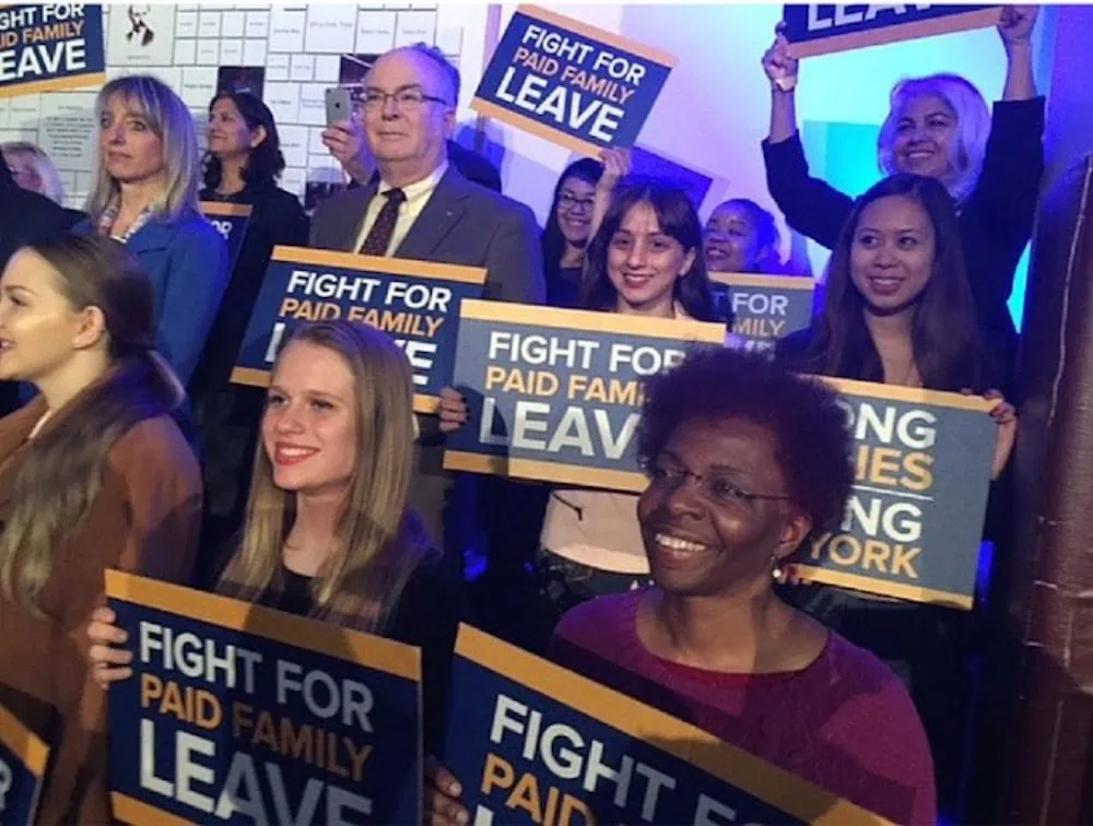 People supporting A Better Balance holding signs saying Fight for Paid Family Leave.
